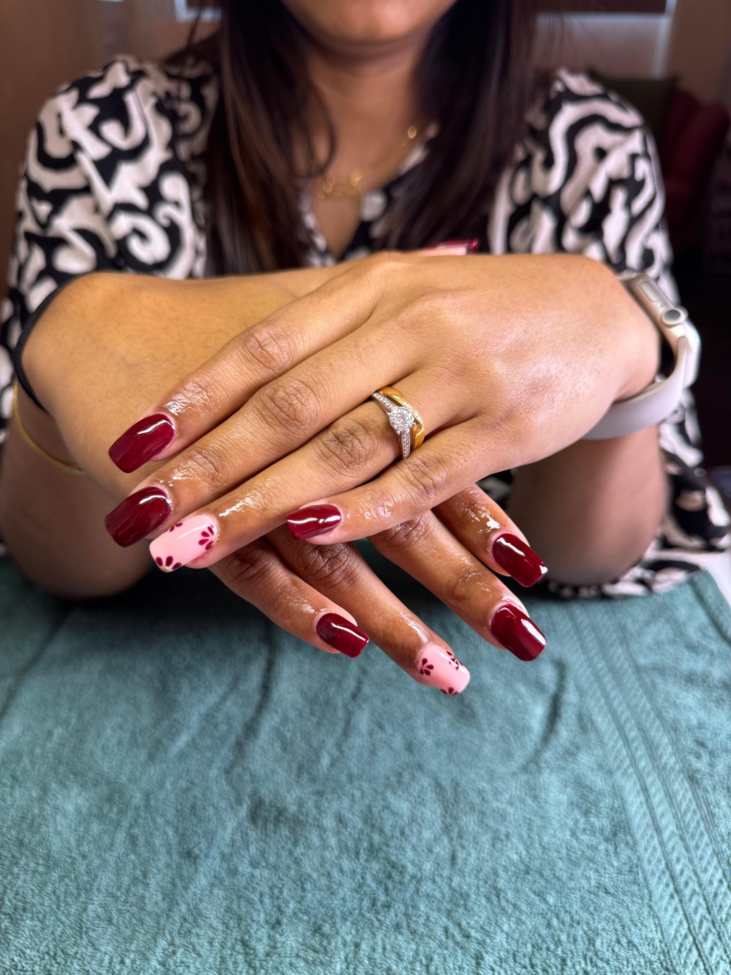 Glossy red floral nail art by Bella’s Nail Studio